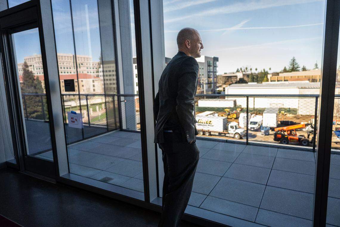 Sacramento Mayor Kevin McCarty looks at the scenery from the second floor of 200 Aggie Square during a tour on Thursday. The first phase of the project is expected to open in May.