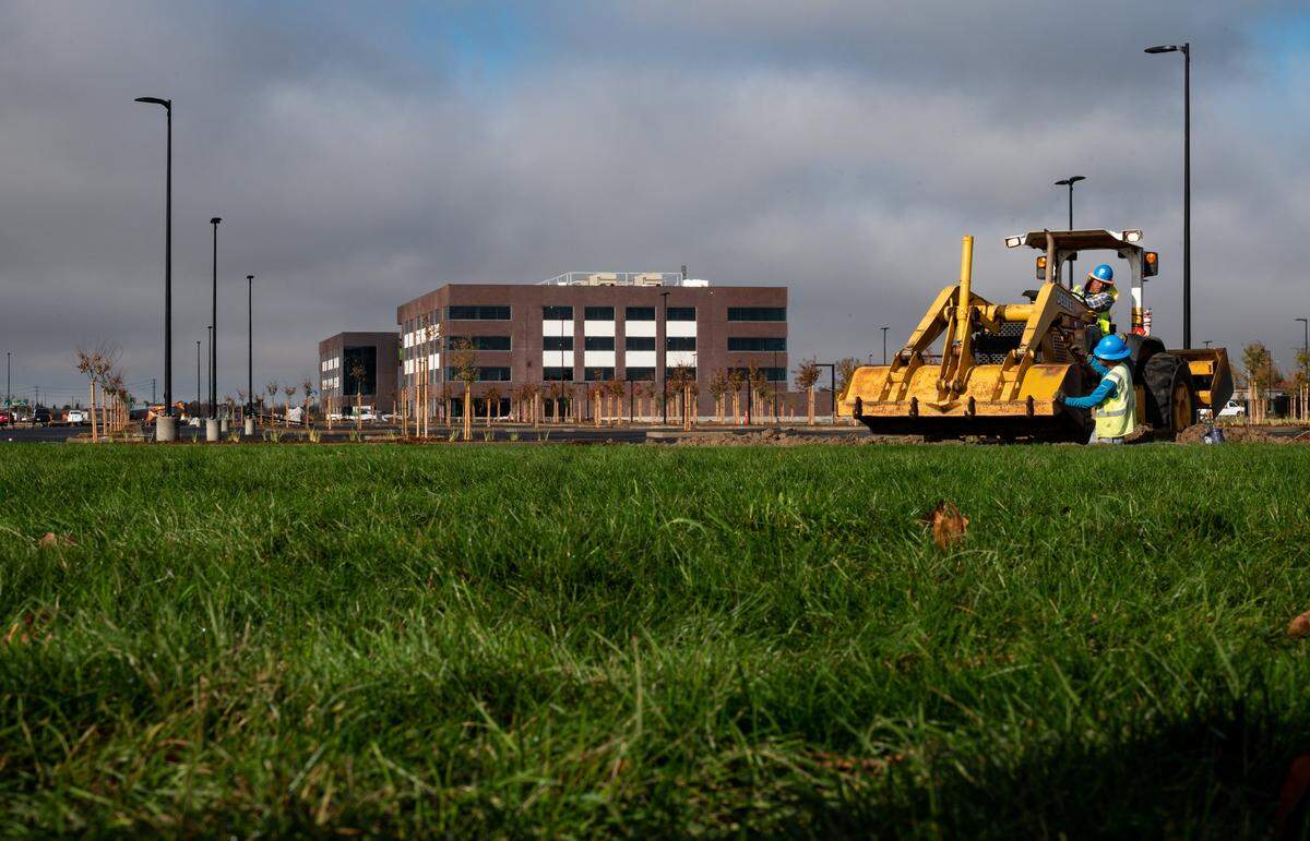 A crew works in a trench near the intersection of Arena Boulevard and East Commerce Way on the new campus for the Centene Corporation, a Fortune 500 national healthcare company, on Tuesday in North Natomas. The headquarters is planned to eventually bring 5,000 jobs to the site off Interstate 5 at Arena Boulevard.