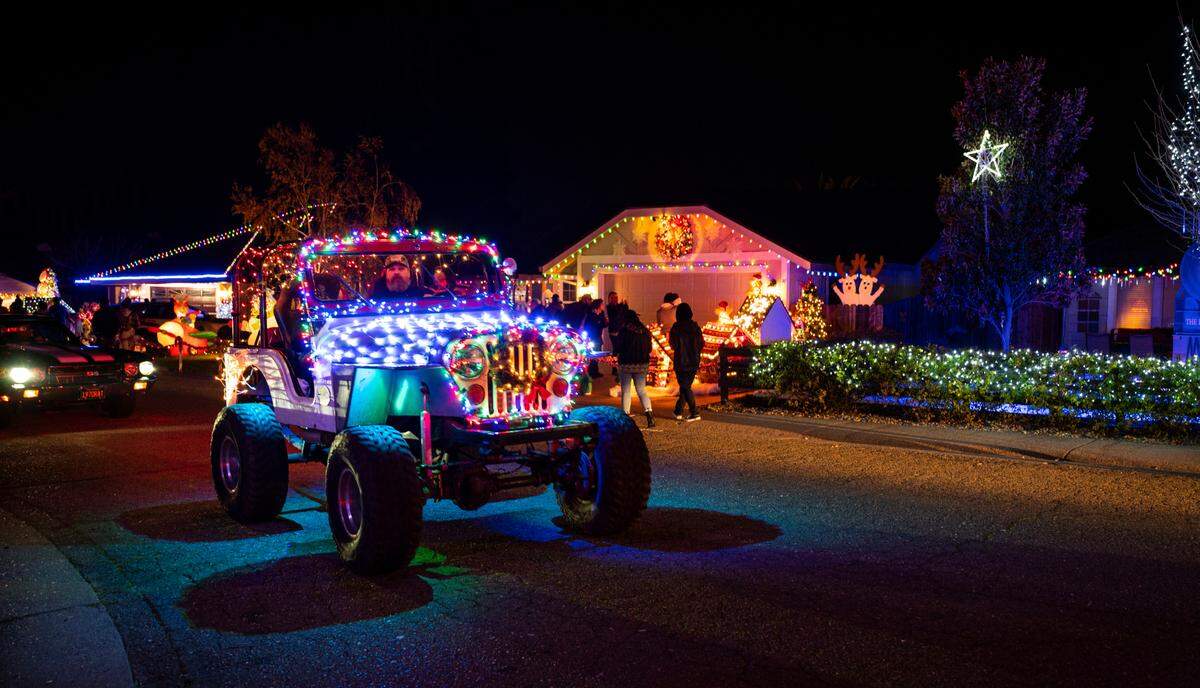 An illuminated Jeep gives off Christmas spirit while touring Dovewood Court in Orangevale on Dec. 5. Each of the 18 homes on the cul-de-sac is extensively decorated with a holiday theme.