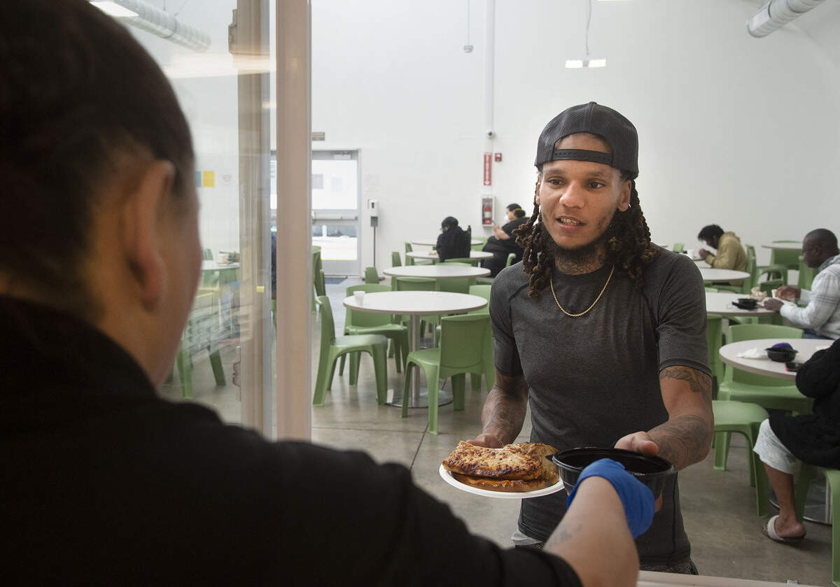 Tyrell Hamilton, 28, a guest at the Volunteer’s of America X-Street Navigation Center gets his lunch on Dec. 1. The X-Street Navigation Center is asking Book of Dreams for donations to buy a new refrigerator for guests to store their own food items.