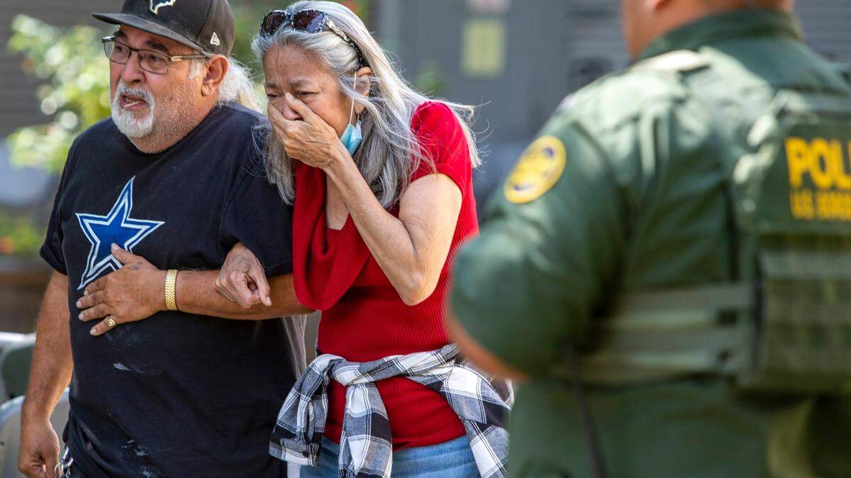 A woman cA woman cries as she leaves the Uvalde Civic Center on May 24, 2022 in Uvalde, Texas where 19 students and two teachers were killed in a mass shooting at a South Texas elementary school. The 18-year-old gunman also died.