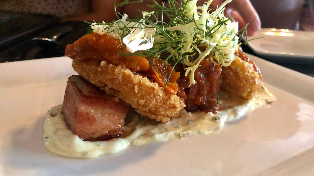 Taylor’s Kitchen makes a fried green tomato appetizer with cubed pork belly.