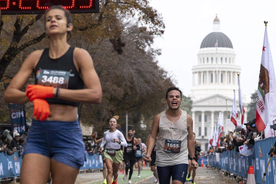 Marathon participants cross the finish line of the California International Marathon in Sacramento on Sunday, Dec. 7, 2025.