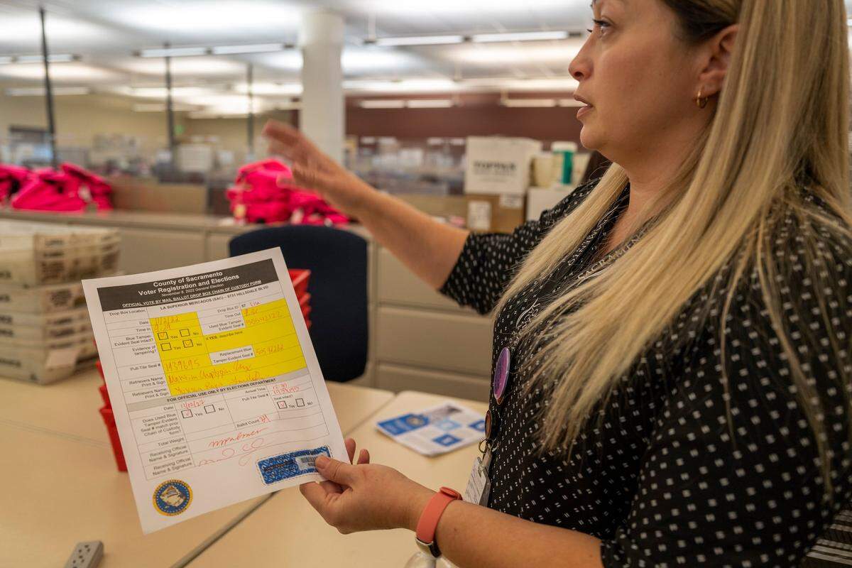 Election manager Karalyn Fox explains how ballots are received and checked in the County of Sacramento on Thursday. “There are a lot of cameras in here and the passage and travel of every ballot is being videotaped,” Fox said.