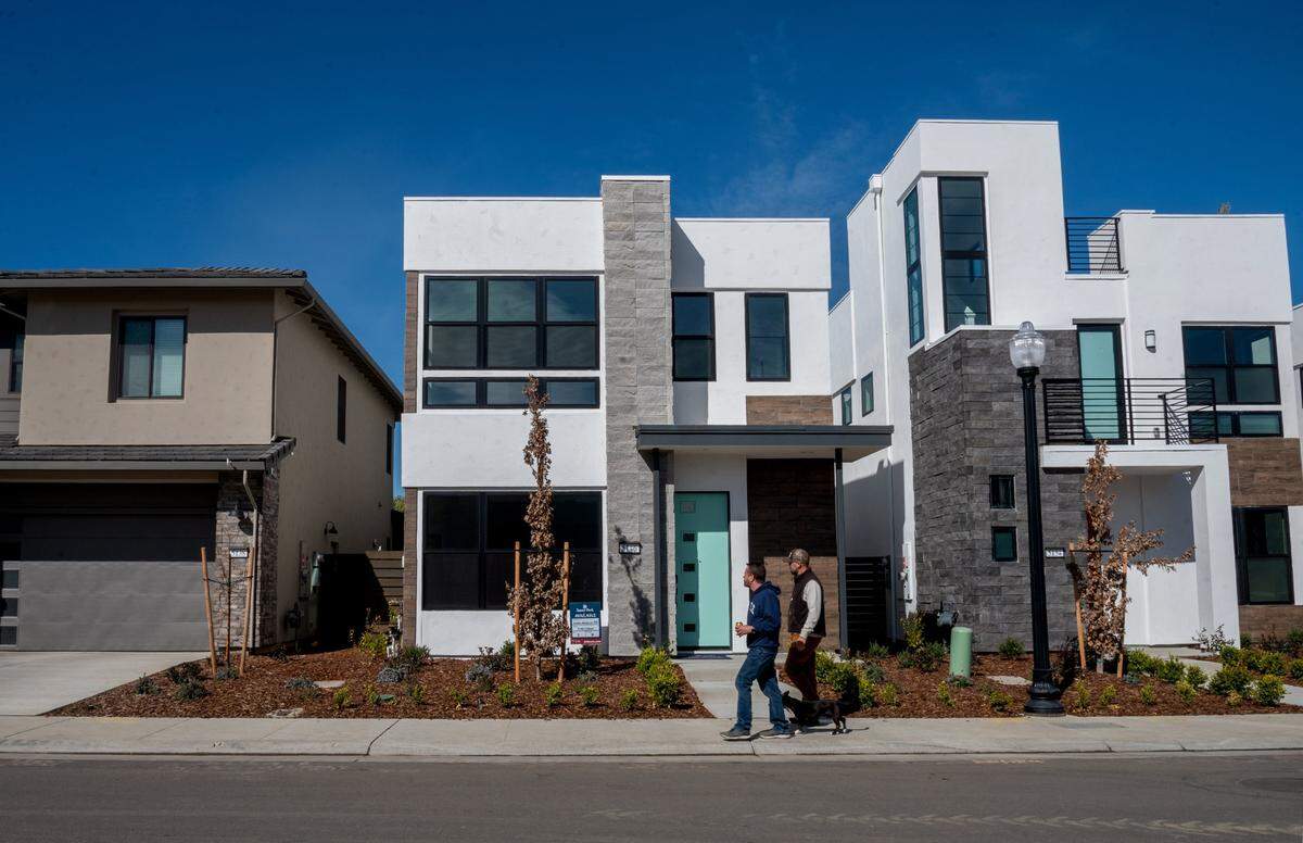 A new home at 5146 E Street with an “available” sign is nestled between two that have sold inside the Sutter Park development in East Sacramento on Tuesday, Feb. 16, 2021.