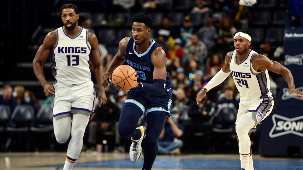 Memphis Grizzlies forward Jaren Jackson Jr. (13) brings the ball up court ahead of Sacramento Kings center Tristan Thompson (13) and guard Buddy Hield (24) in the second half of an NBA basketball game Sunday, Nov. 28, 2021, in Memphis, Tenn. (AP Photo/Brandon Dill)