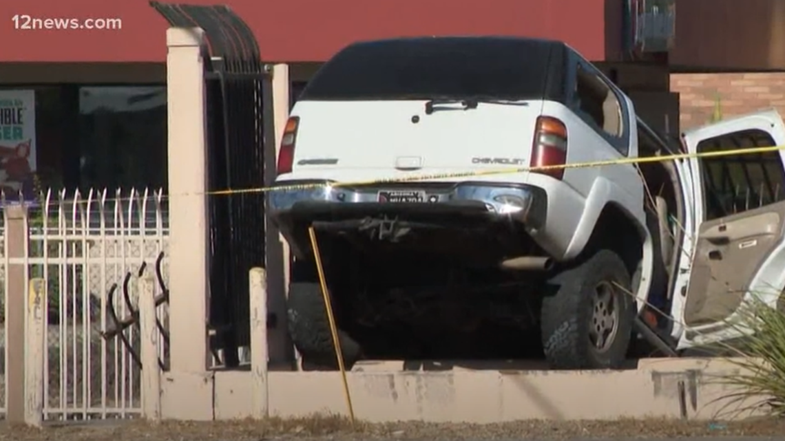 A man crashes his car into a canal retention wall after another driver shoots him in the head on Oct. 21, 2021, in Phoenix over a road rage fight, police said. His 2-year-old son and girlfriend were in the car.
