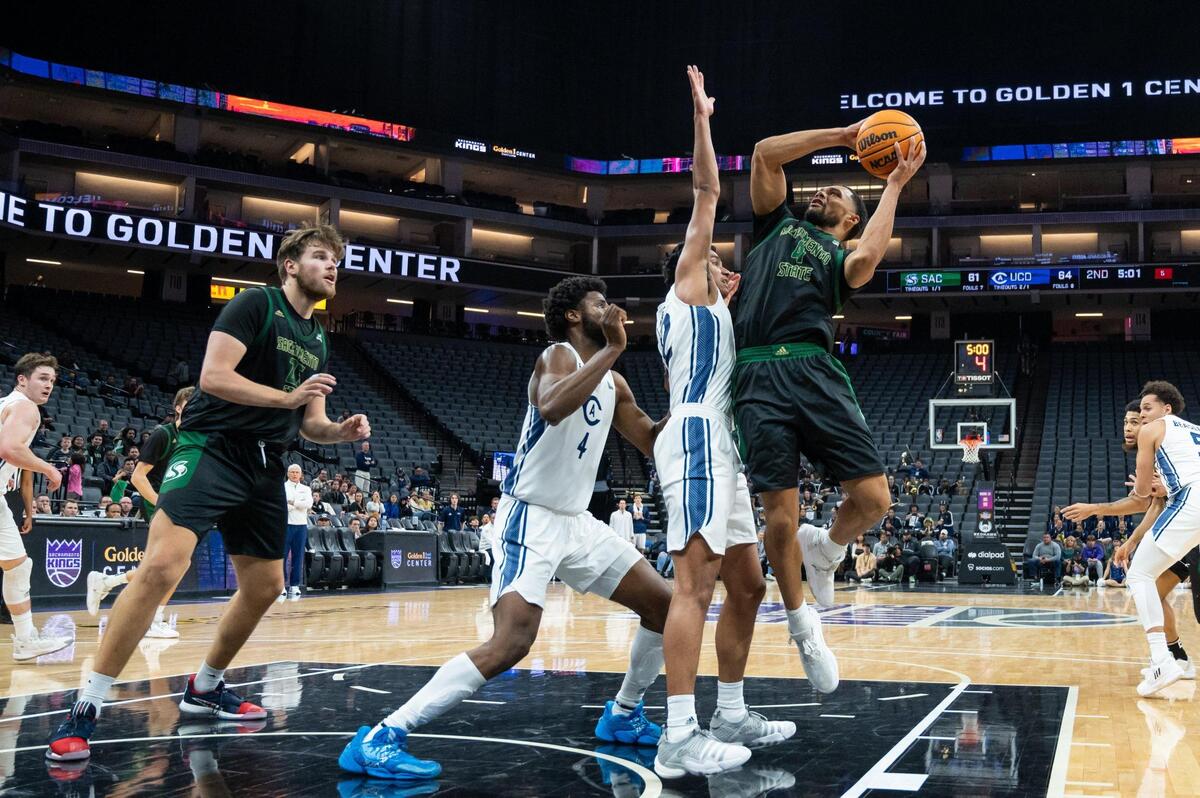 Sacramento State Hornets guard Zach Chappell (4) makes the layup and draws the foul from UC Davis Aggies guard Sione Lose (22) and makes the free throw during the second half in the Causeway Classic on Tuesday, Nov. 22, 2022, at Golden 1 Center in Sacramento. The Aggies won 82-71.