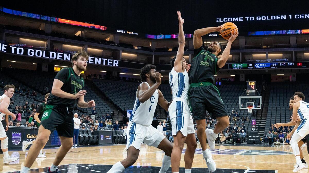 Sacramento State Hornets guard Zach Chappell (4) makes the layup and draws the foul from UC Davis Aggies guard Sione Lose (22) and makes the free throw during the second half in the Causeway Classic on Tuesday, Nov. 22, 2022, at Golden 1 Center in Sacramento. The Aggies won 82-71.