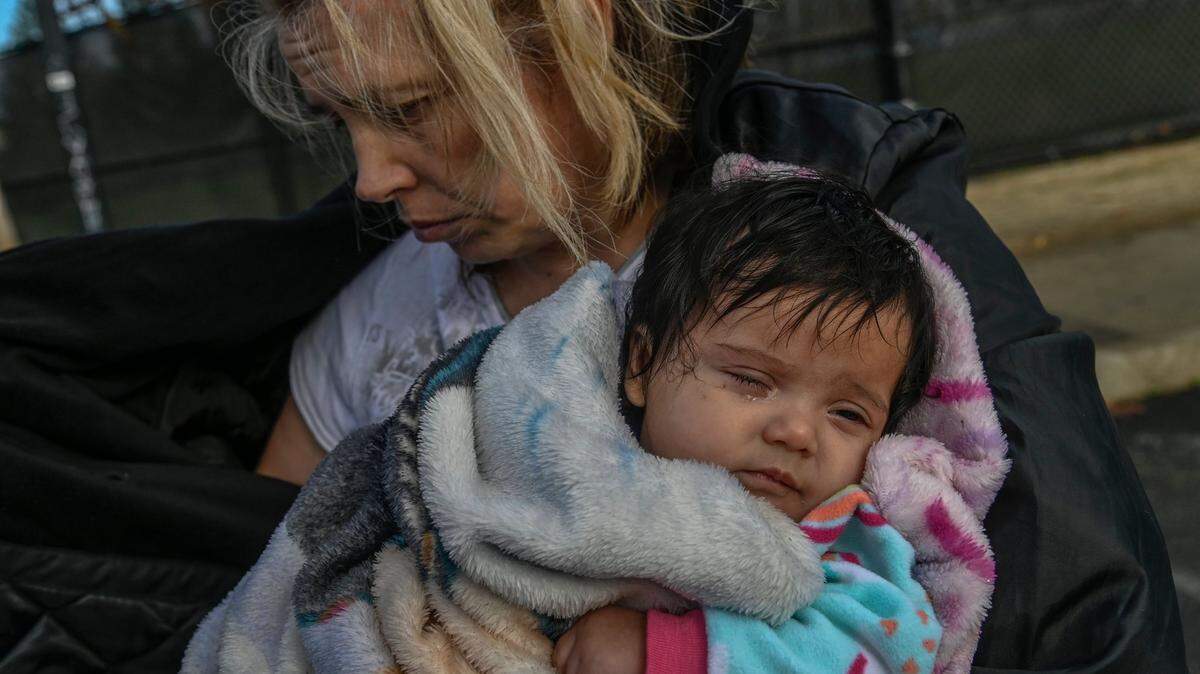 Geri Wells, 36, holds 3-month-old daughter Orion Gonzales in a park in Rancho Cordova in 2021. When children end up on the streets, the rest of life is an uphill battle. 