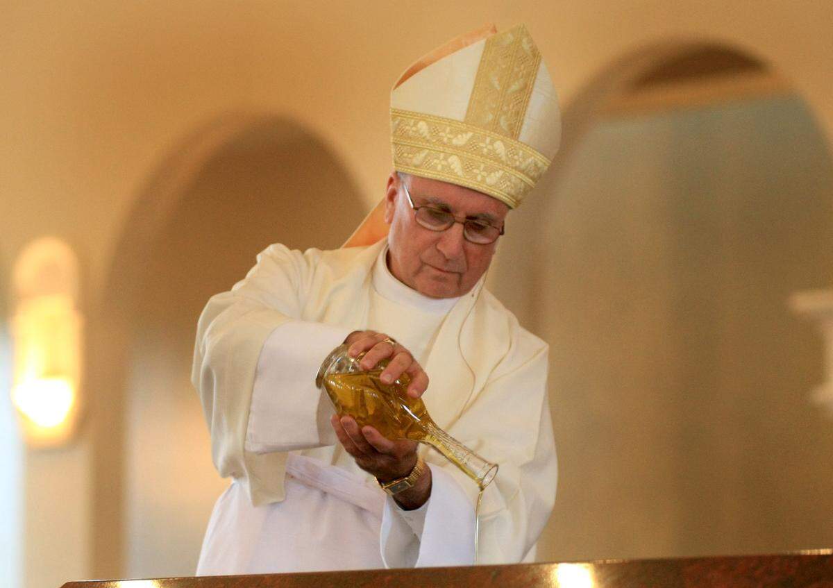 Bishop Stephen Blaire pours holy oil during the dedication at St. Stanislaus Church in Modesto in 2009.