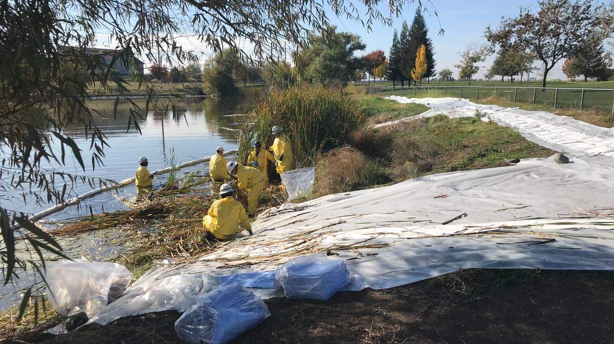 Spill-response teams use absorbents and other materials to clean out a diesel release at Tanzanite Community Park in Sacramento’s Natomas Crossing area. The spill was reported to state emergency officials Monday, Nov. 14, 2022.
