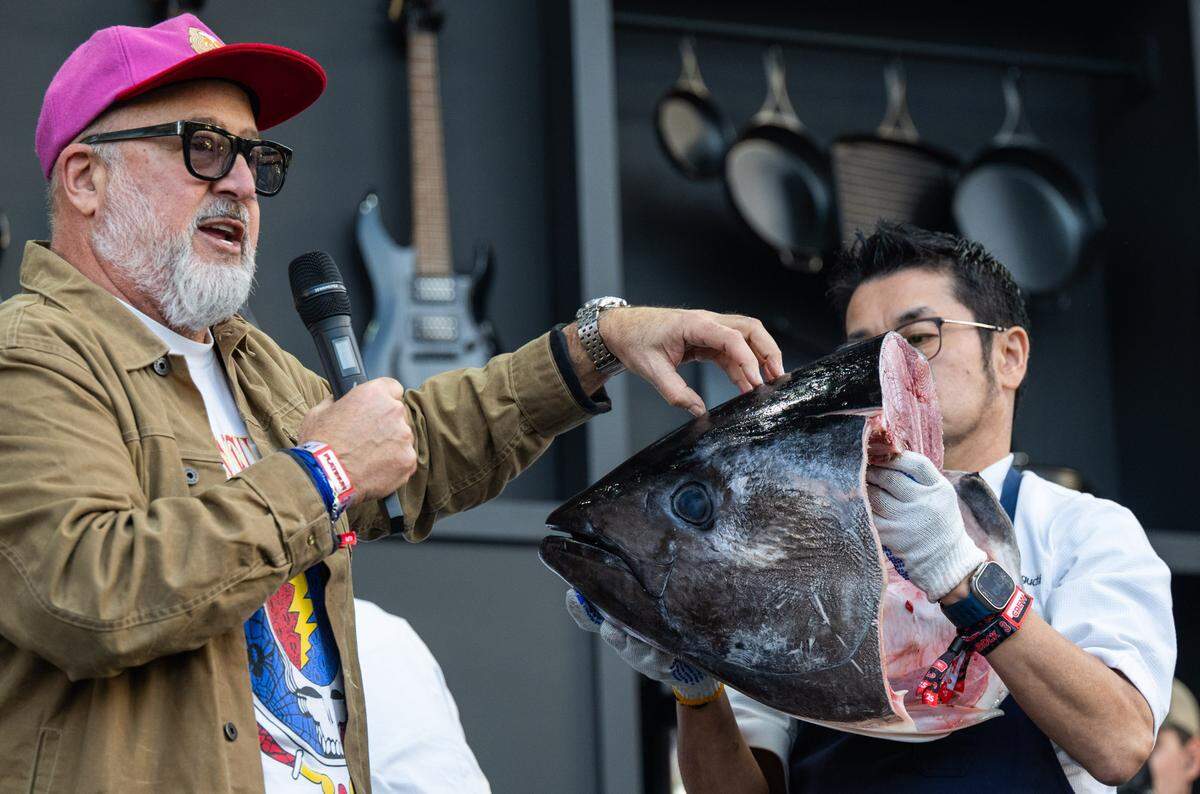 Celebrity chef Andrew Zimmern talks about some of the delicacies that can be found in the head of a tuna, recently removed by chef Masaharu Morimoto, during  a cooking demonstration at the BottleRock music festival in Napa on Friday, May 23, 2025. 