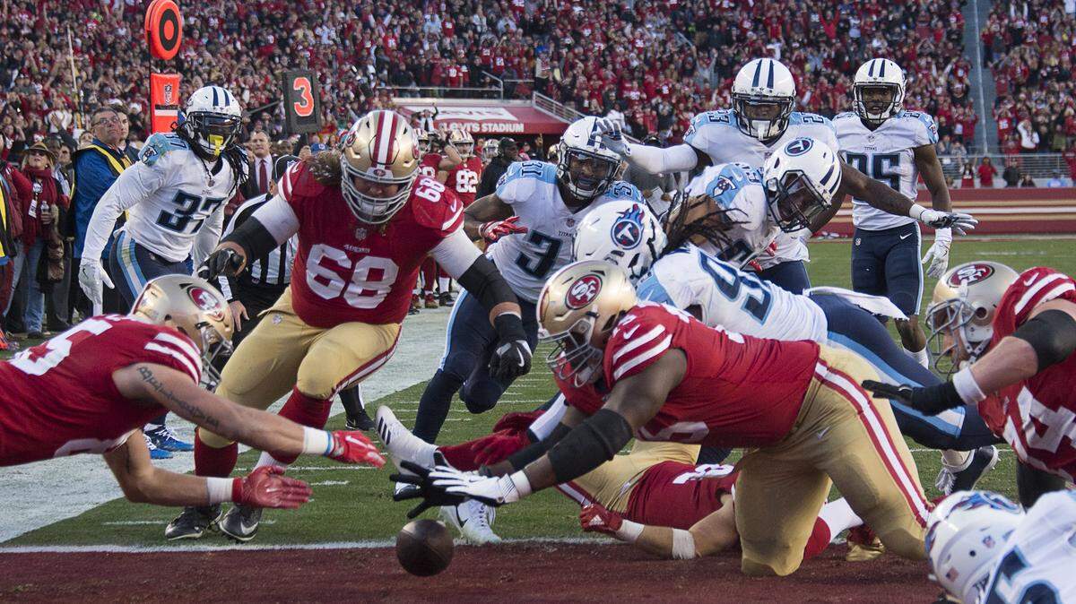 The 49ers' Trent Taylor (81) fumbles the ball and it is recovered by teammate Laken Tomlinson (75) in the fourth quarter during a game Dec. 17, 2017. The 49ers on Friday signed left guard Tomlinson to a three-year contract extension, locking in place four-fifths of their offensive line for the near future.