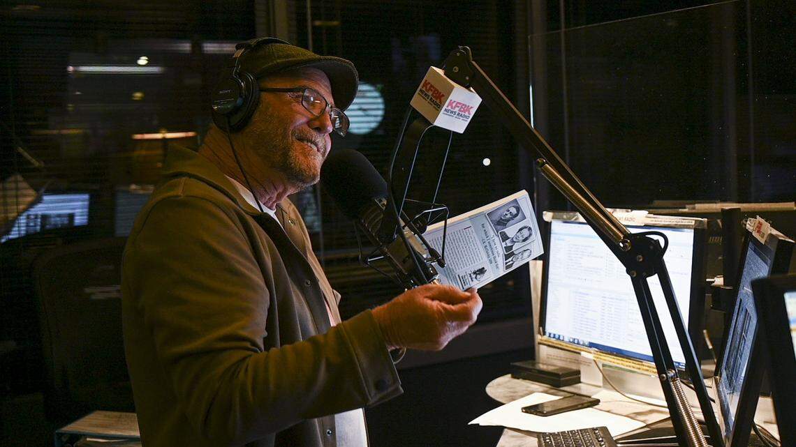 News radio anchor Pat Walsh holds up the book “Sacramento on the Air” by Annette Kassis about the McClatchy family’s impact on West Coast broadcasting during a special broadcast on The Pat Walsh Show on Friday, Sept. 16, 2022, about the 100th anniversary of the station’s launch in 1922.