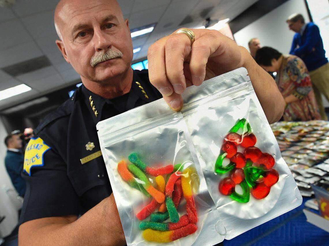 Then-Fresno Police Chief Jerry Dyer, who is now mayor, holds gummy candies infused with THC, part of a 150-pound seizure of edibles from a Fresno marijuana dispensary, with the fear of such candies falling into the hands of children, during a news conference at police headquarters, May 2, 2018.