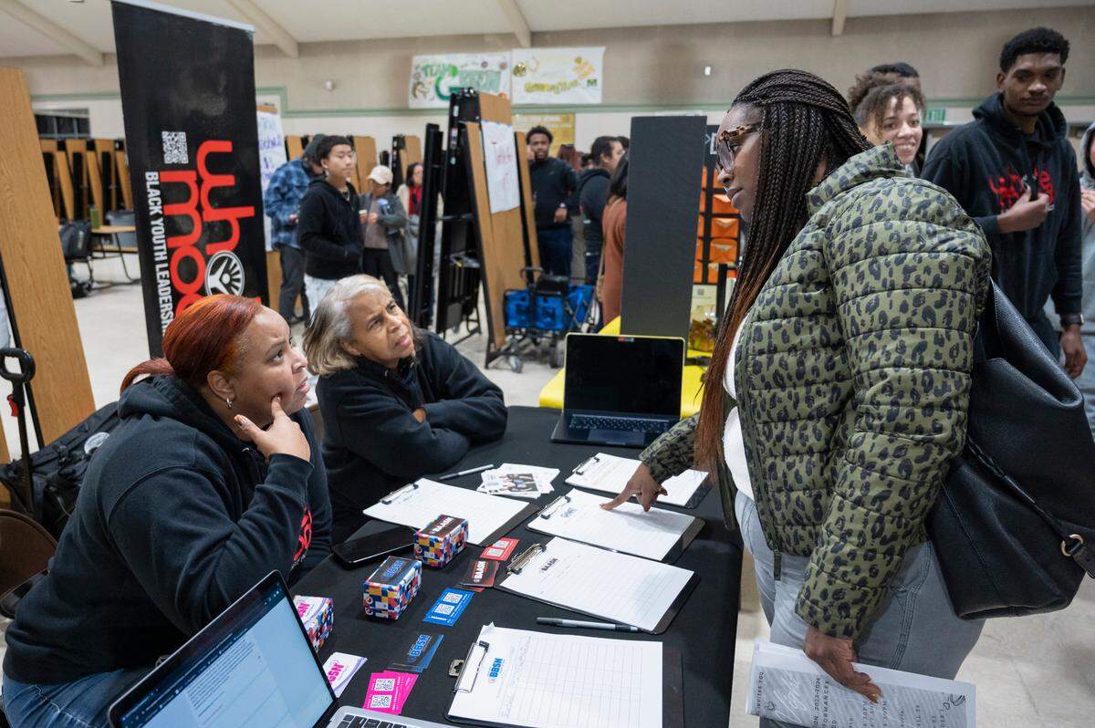 Lorreen Pryor, left, president of the Black Youth Leadership Project, and senior program director Candy Jackson, center, listen to Jacquelyn Kendricks, right, at an open house at Monterey Trail High School in Elk Grove on Thursday, Jan. 11, 2023. “I was finding out how to support my daughter as her moves into high school,” Kendricks said. “And how to support African American students in the school, to get their needs met and be able to find the resources they need to be successful.”