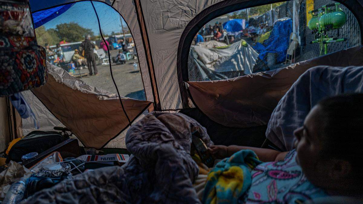 Holly Porter, who is functionally quadriplegic, listens to civil rights lawyer Mark Merin as he talks to residents at Camp Resolution on Tuesday, Nov. 15, 2022, the day before the city gave residents notice to leave the homeless encampment in North Sacramento. The only thing the city offered them were bus passes as all shelters are full.