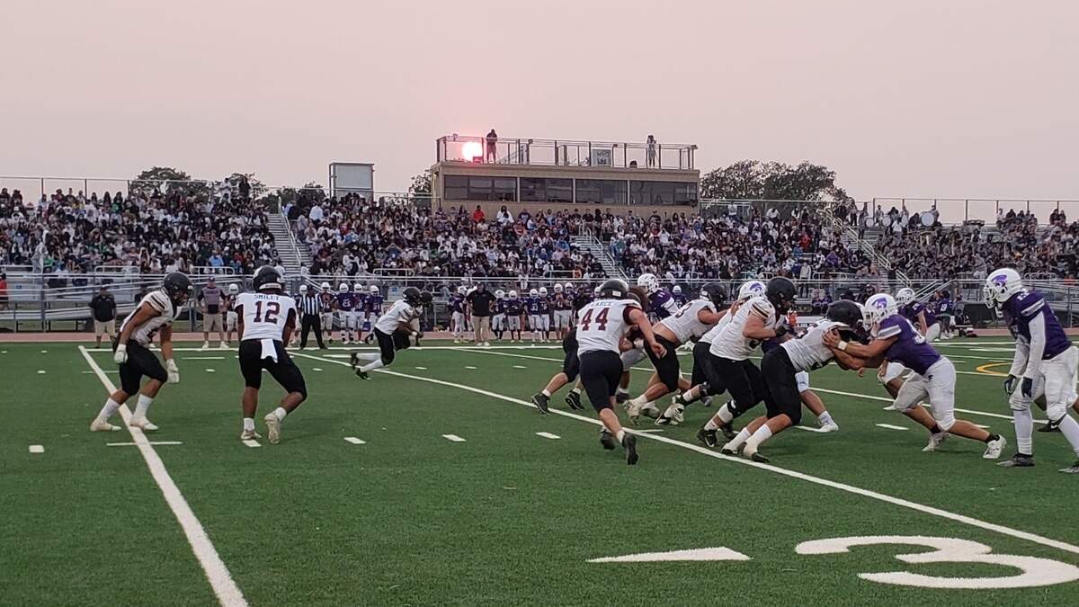 Whitney’s Anthony Parker takes a handoff against Franklin High School on Friday night.