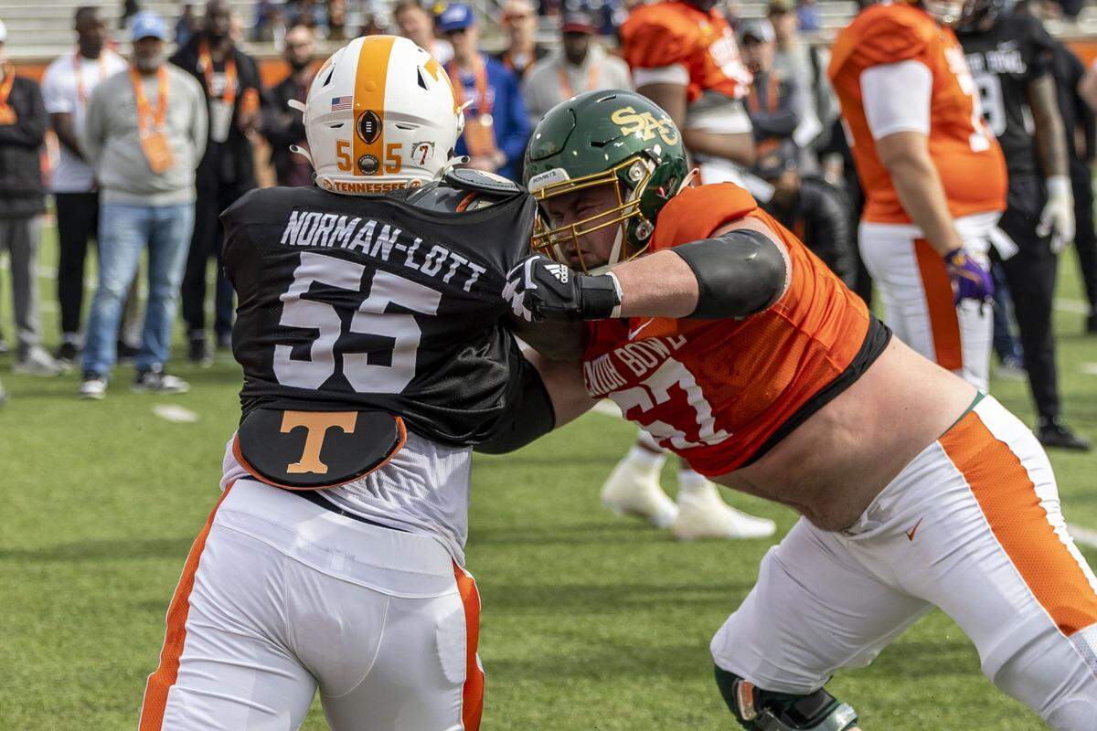 Jan 28, 2025; Mobile, AL, USA; American team defensive lineman Omarr Norman-Lott of Tennessee (55) spars with American team offensive lineman Jackson Slater of Sacramento State (67) during Senior Bowl practice for the American team at Hancock Whitney Stadium. Mandatory Credit: Vasha Hunt-Imagn Images