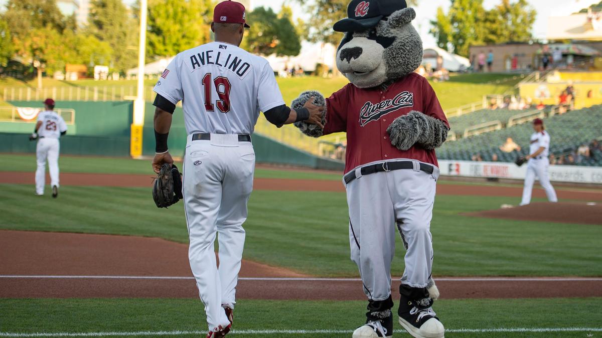 Dinger gives shortstop Abiatal Avelino a high five as the River Cats take the field Tuesday, Sept. 10, 2019, during game one of the PCL Championship against the Round Rock Express at Raley Field.
