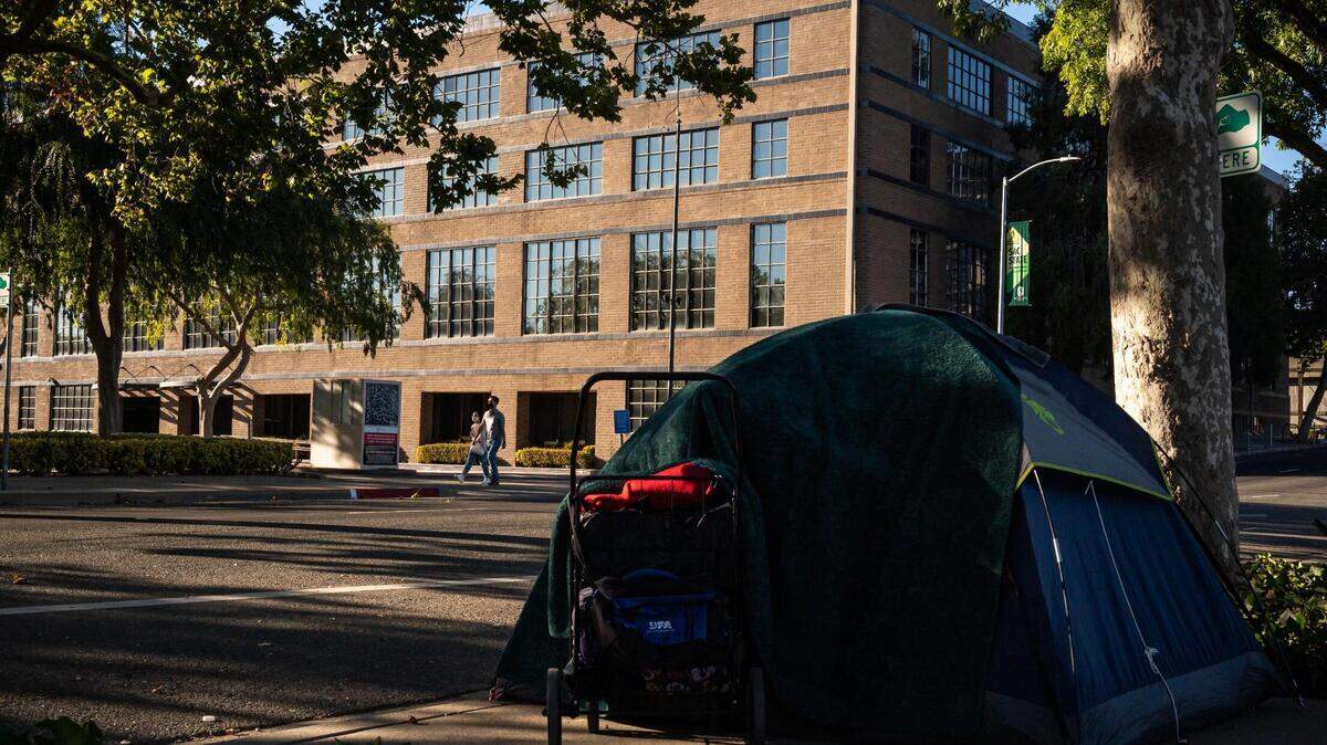 Jasmine Belarmino and her boyfriend, John, slept in a tent in 2022 across the street from a five-story building at Third and R streets. Recent state and court actions gives Sacramento more options to manage homelessness.