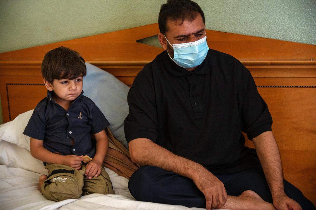 Sitting in a cramped North Highlands hotel room, Abdullah snacks on a cracker as his father Abdul talks on Aug. 26 about the fear he felt as their plane sat for hours on tarmac at the Kabul airport as Afghanistan’s government fell to the Taliban. The first thought Abdul said he had upon landing in the U.S.: “I feel safe.”