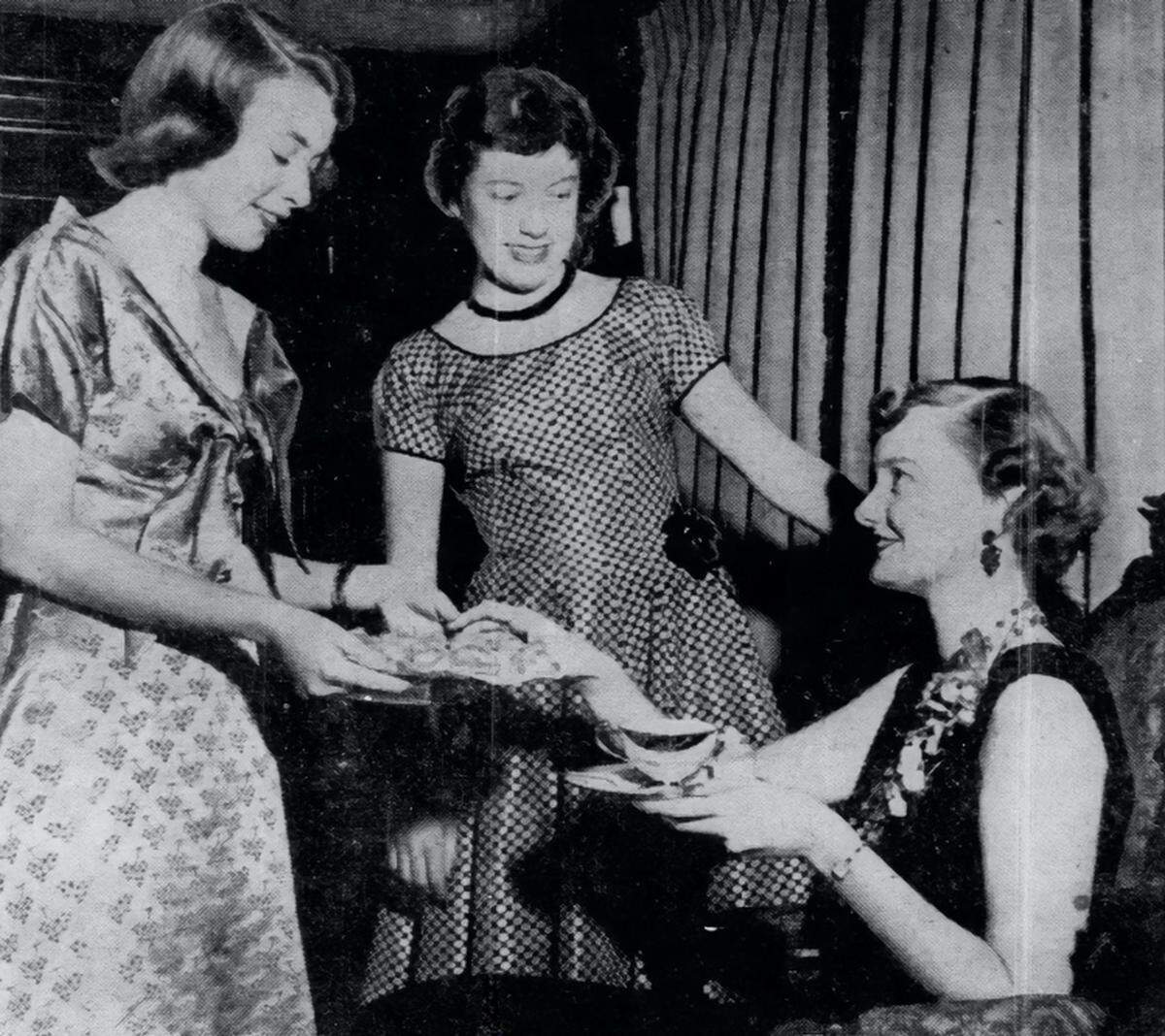 Joan Didion, left, serves tea to recently engaged Carol Emigh, right, at the Didion home in 1954.