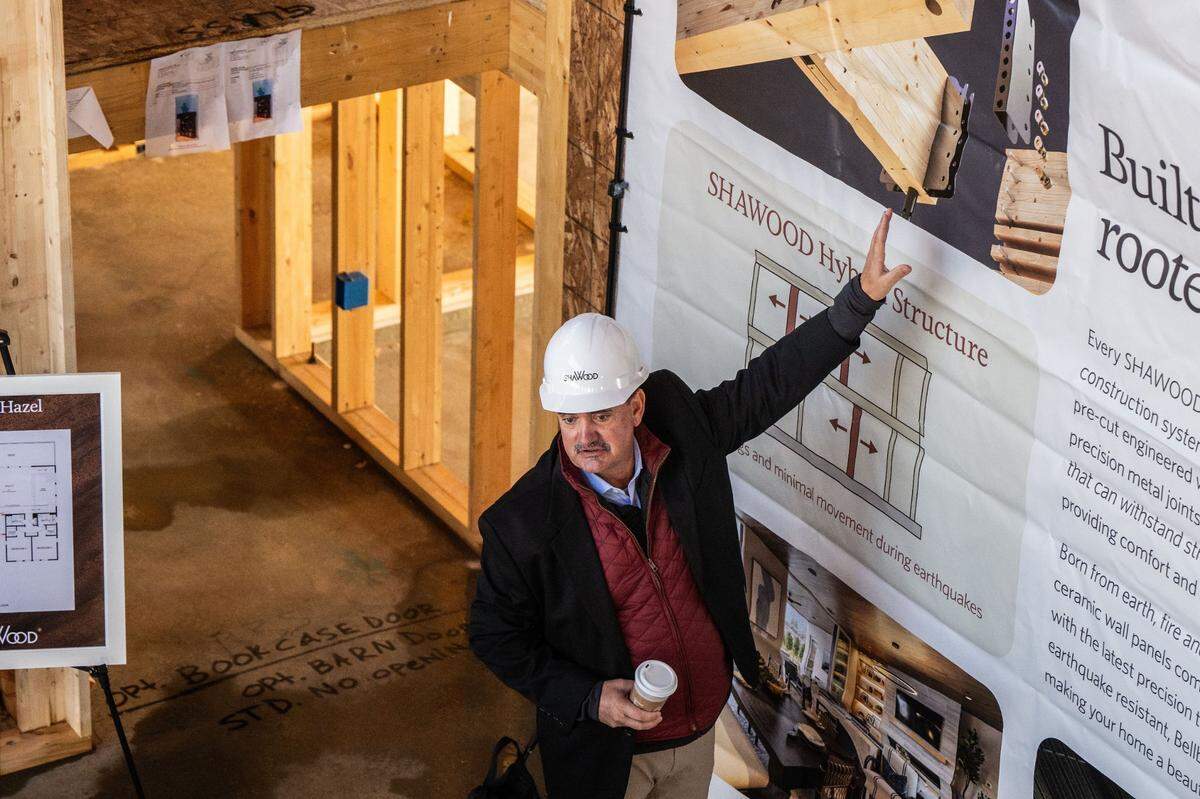 Troy Wood, manager for engineering for homebuilder Sekisui House, explains on Monday the proprietary metal joints that are used to connect the laminated beams and posts in the Shawood homes.