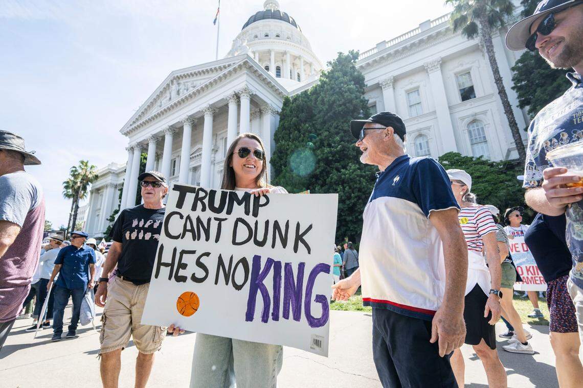 Sacramento Kings fan Marissa Meyers holds a sign during the “No Kings” protest in the state Capitol on Saturday, June 14, 2025.