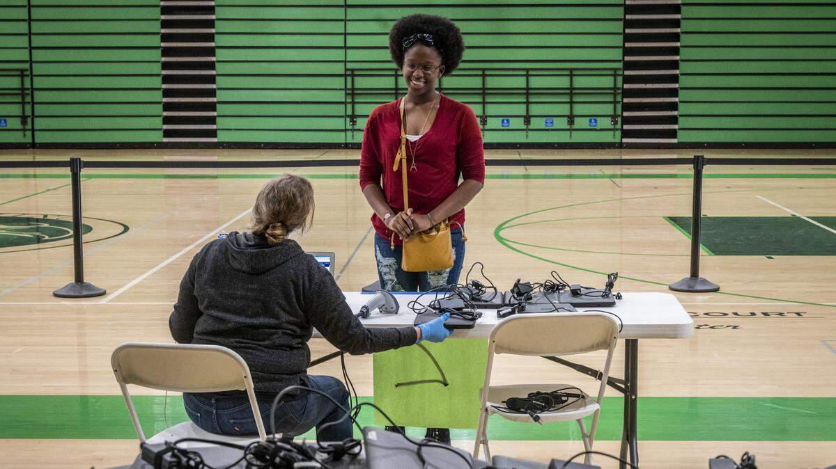 Sophomore Aniyah Simms smiles as she picks up a computer at El Camino Fundamental High School in Arden Arcade on Monday, March 30, 2020. The San Juan Unified School District is distributing Google Chromebooks for distance learning as schools are closed because of the coronavirus.