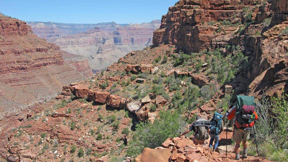 A group of hikers descend the Hermit Trail in Grand Canyon National Park.