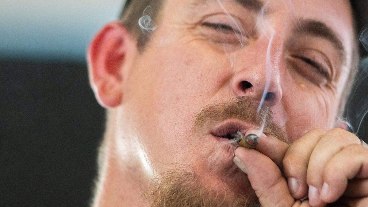 John Mitchell smokes a prerolled joint in the cannabis consumption lounge on Tuesday, July 16, 2024, during the California State Fair in Sacramento. Mitchell said using cannabis products helps him wind down and gives him a sense of “mental bliss.”