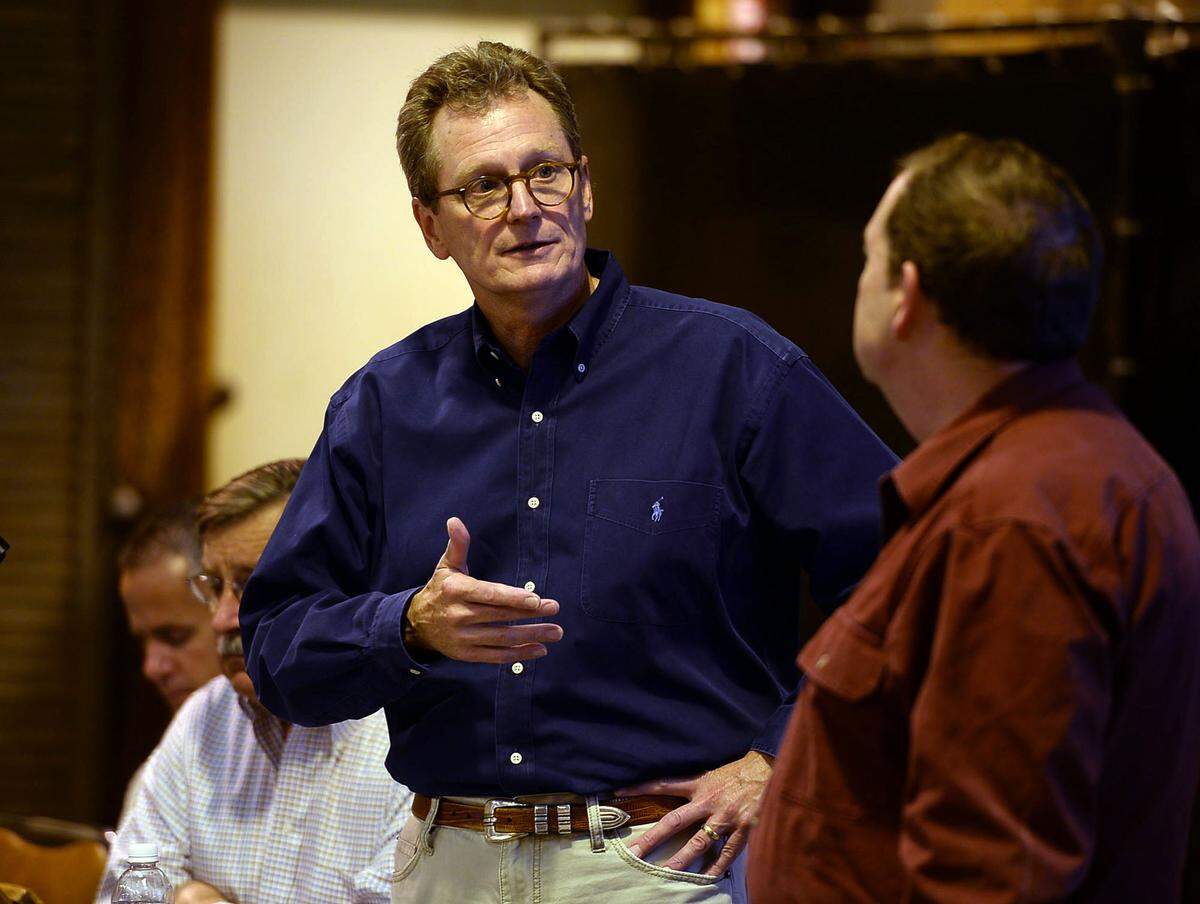 Westlands Water District’s Tom Birmingham speaks with Ron Milligan, right, operations manager for the Central Valley Project, during a 2013 meeting with farmers in the district about summer water allocations. Farmers’ allotments were trimmed drastically after federal agencies reduced water pumping in the Sacramento Delta to protect endangered fish.