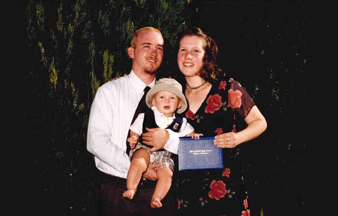 Aaron and Sara Easton pose with Oliver at her high school graduation ceremony.