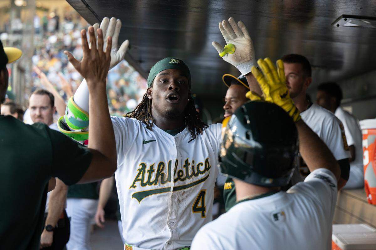 Athletics outfielder Lawrence Butler (4) celebrates in the dugout after a inside the park homer off Atlanta Braves pitcher Didier Fuentes (75) in the bottom of the first inning on Tuesday July 8, 2025 at Sutter Health Park in West Sacramento. 