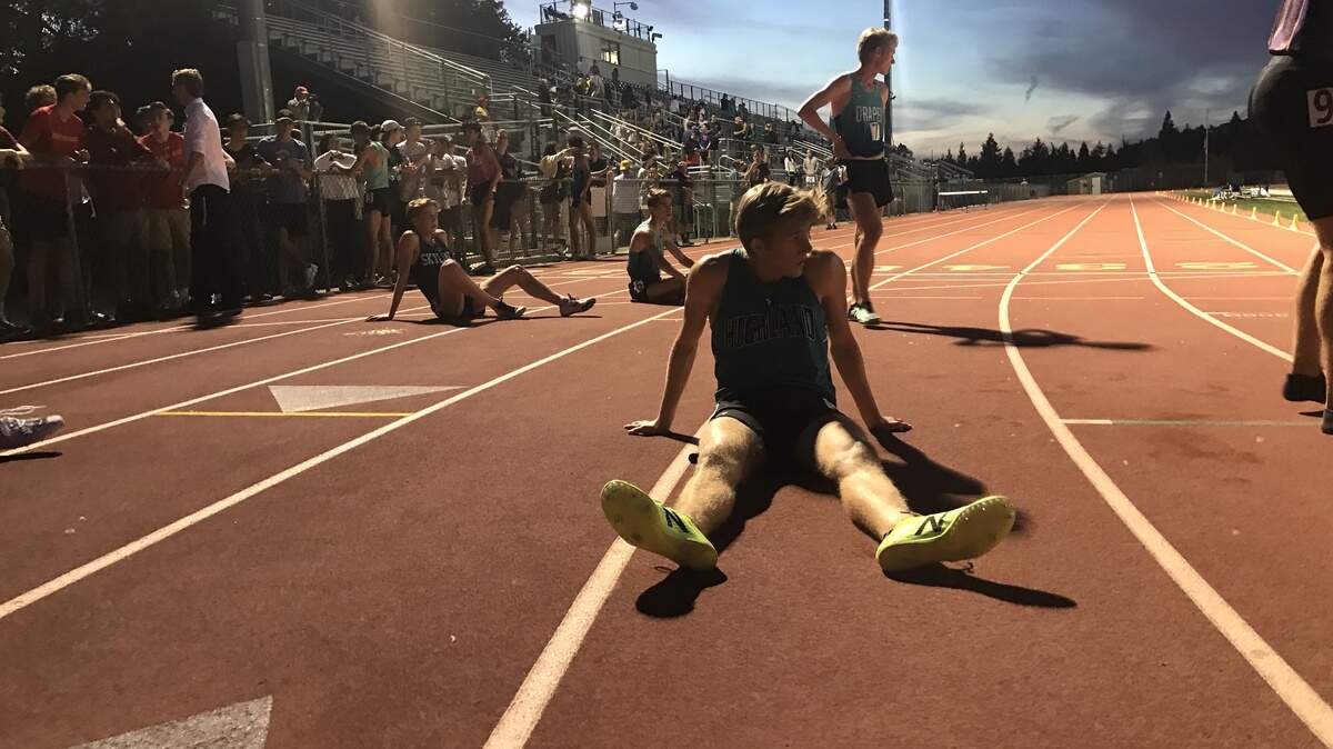 Leo Daschbach rests on the track at Oak Ridge High School after running a mile in less than four minutes Saturday.