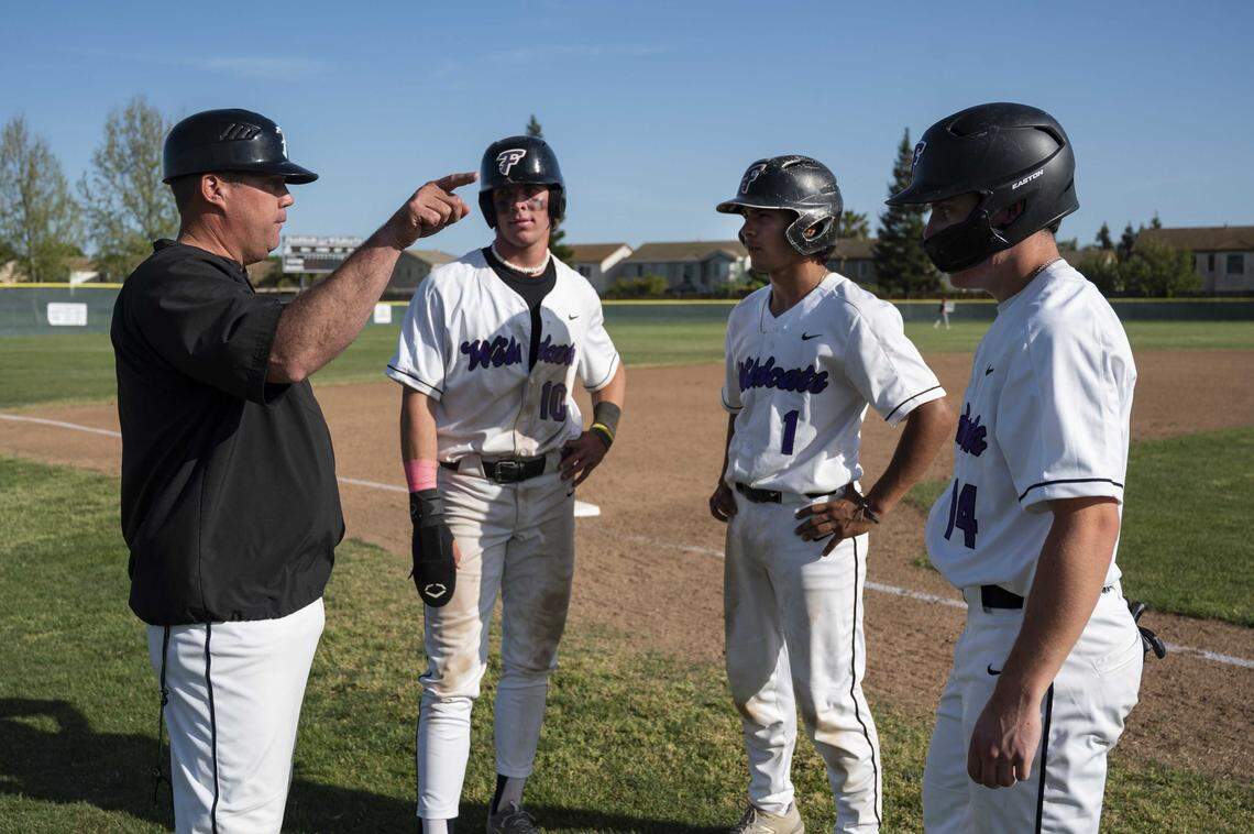 Franklin Wildcats coach Bryan Kilby talks with, from left, Zach McCargar (10), Jaydn Ramos (1) and Tim Johnson (14) during a pitching change in a game against Pleasant Grove at Franklin High School in Elk Grove in 2023. Kilby reached his 300th career varsity win Friday after building Franklin into a perennial Delta League and section contender.