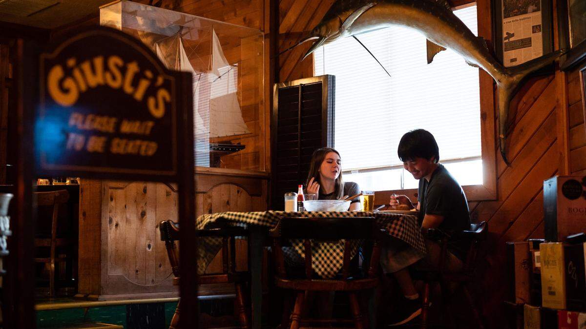 Emily VanderMey, left, and fellow traveling art student James Tolley have dinner at Giusti’s in Walnut Grove on the Sacramento-San Joaquin Delta on Friday, July 23, 2021.