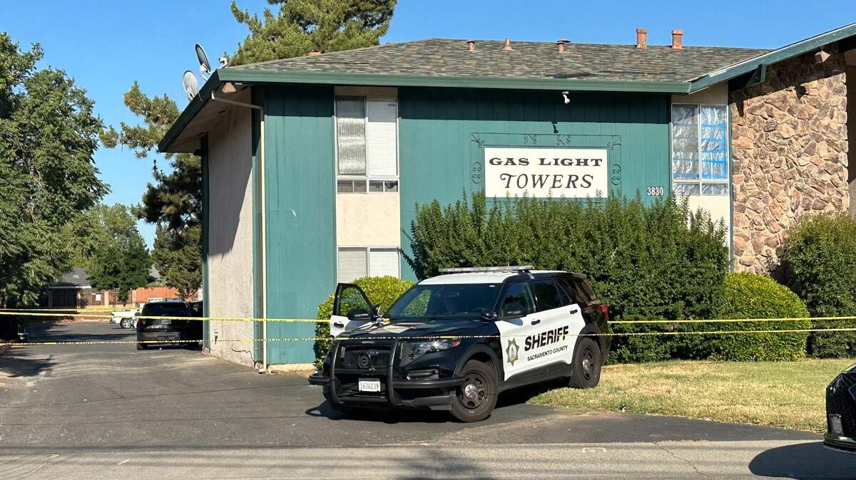 Sheriff’s patrol cars are stationed outside the Gas Light Towers on the 3800 block of Annadale Lane following a shooting that left one man dead and one woman wounded Friday in Arden Arcade.