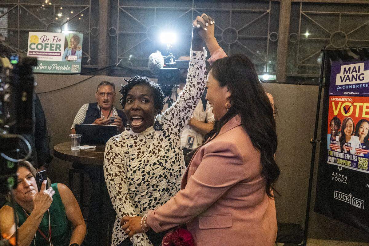 Sacramento supervisor candidate Flojaune Cofer is celebrated by Sacramento City Councilmember Mai Vang, a candidate for the 7th Congressional District, during their election night party at the Lock & Key in midtown Sacramento on Tuesday.