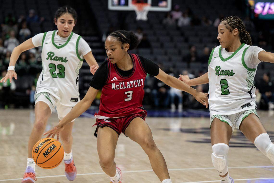 The McClatchy Lions' Tori Comfort (3) is chased by the St. Mary's Rams’ Amani Rafiq (23) and Aynya Hardy (2) in the second half of the CIF Sac-Joaquin Section Division I championship game on Saturday at Golden 1 Center.
