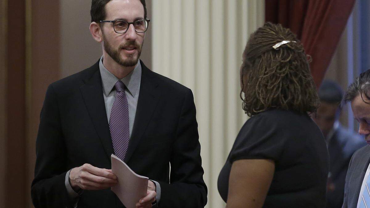Sen. Scott Wiener, D-San Francisco, left, talks with Sen. Holly Mitchell, D-Los Angeles, at the Capitol.