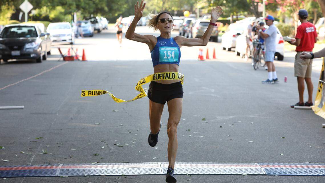 Sacramento resident Jenny Hitchings crosses the finish line at the Susan B. Anthony 5K race as she breaks Shirley Matson’s 21-year-old American record with a 18:05 time in Sacramento on Saturday, Aug. 11, 2018.