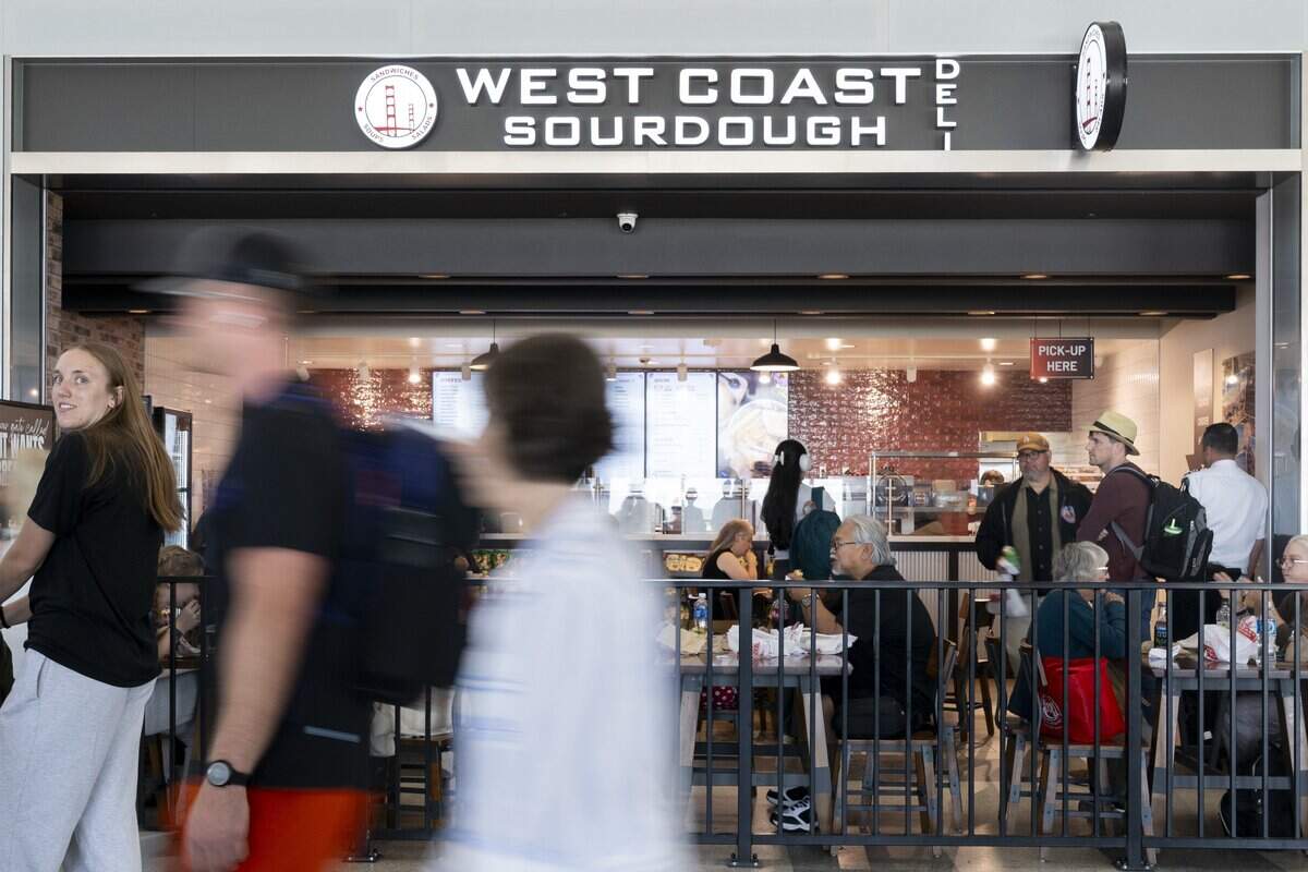 People walk past the West Coast Sourdough Deli in terminal B at Sacramento International Airport on Wednesday, June 17, 2026.