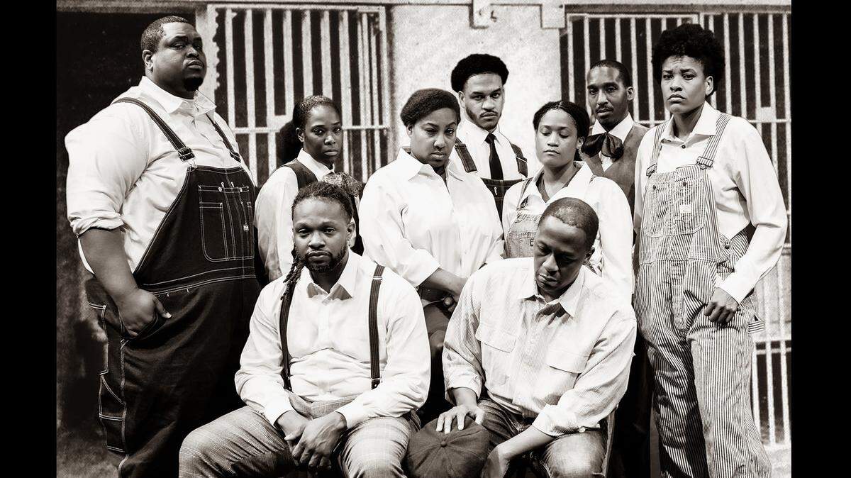 The cast of “Direct From Death Row: The Scottsboro Boys” is depicted in a 1930s-era jail cell. The production runs through March 5.
