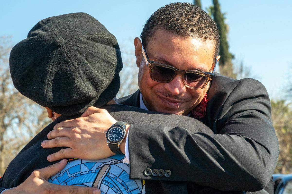 Marketing executive Ronald West is hugged outside after his mother Georgia West’s celebration of life memorial service at Saint Paul Church in Sacramento on Thursday, Jan. 23, 2024.