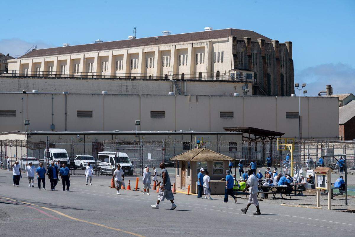 Inmates exercise outside in the yard at San Quentin State Prison in San Rafael on Wednesday, July 26, 2023. Senate Bill 94 would allow some inmates convicted of crimes that took place before mid-1990 to petition a judge to have their sentences changed and seek parole.  