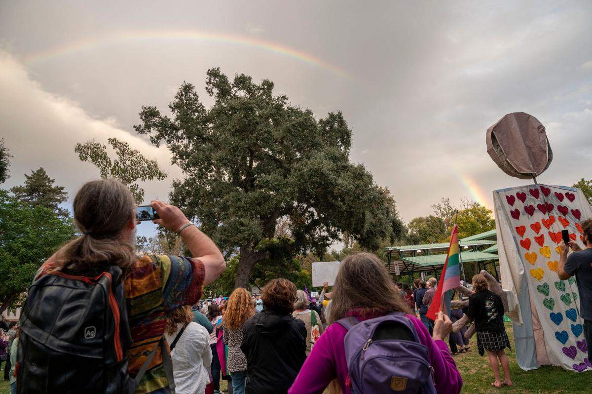 A rainbow forms in the sky above a 2023 "Yolo is for Everyone" rally in Davis Central Park.