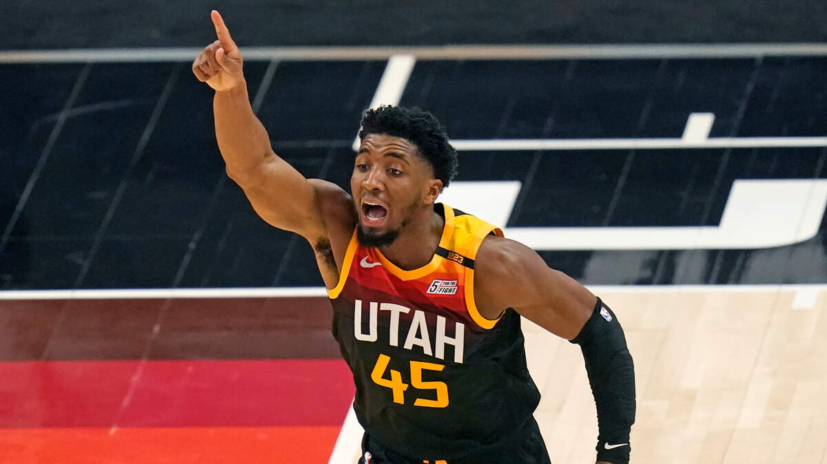 Utah Jazz guard Donovan Mitchell (45) directs his team as he runs upcourt in the second half during an NBA basketball game against the Miami Heat, Saturday, Feb. 13, 2021, in Salt Lake City. (AP Photo/Rick Bowmer)